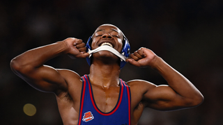 D1 college wrestler unbuckling wrestling headgear after a match