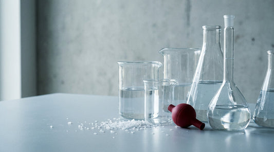 Electrolysed water and HOCl: clean glass vessels of clear brine in soft science-lab light