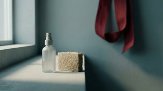 A clear skin mist bottle beside a natural soap bar, comparing two post-training cleansers
