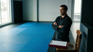 Gym hygiene policy for coaches: a coach overseeing a clean, well-kept training mat
