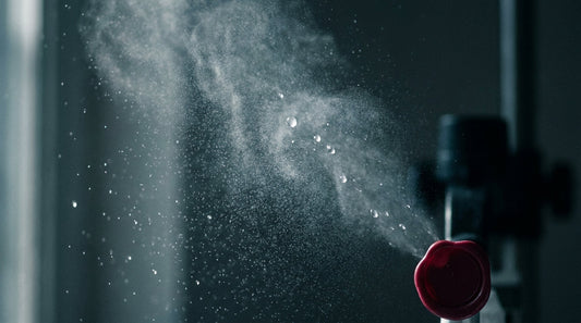How hypochlorous acid works: a fine clear HOCl mist catching the light against a dark background