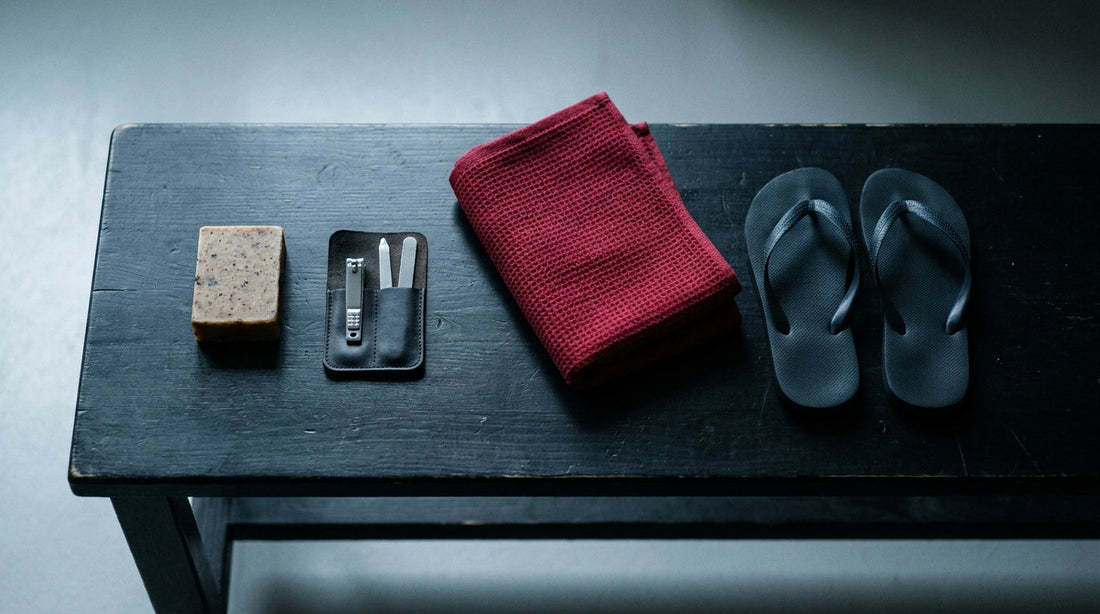 Combat sports hygiene kit laid out - soap bar, nail kit, towel and flip flops