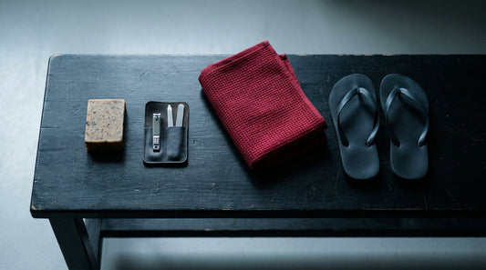 Combat sports hygiene kit laid out - soap bar, nail kit, towel and flip flops