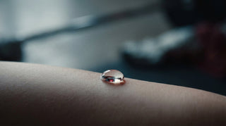 Macro of a clear droplet on calm skin illustrating gentle hypochlorous acid cleansing